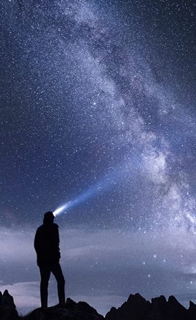 Picture of a tourch shining into the night sky